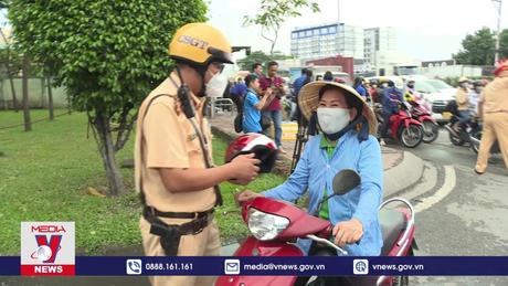 CSGT phát nước suối, mũ bão hiểm cho người dân chơi Lễ